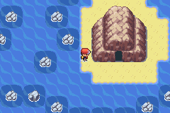 The player on the sand of a small rocky islet in the sea east of Resort Gorgeous, west of the dark opening of the Lost Cave