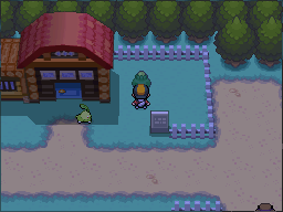 The green-Apricorn tree is beside the farm building and sign. in Pokémon HeartGold.