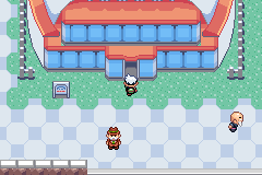 The player at the door of the Battle Dome, a stadium with an arched red roof over a row of blue windows