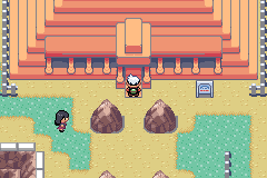 The player at the entrance of the Battle Pyramid, its orange stepped tiers rising above the sand