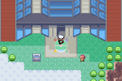 The Emerald Battle Tower’s glass front at the Battle Frontier, with the player at its door