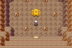 Regirock standing in the middle of the Desert Ruins chamber with the player one step in front of it
