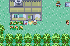 Professor Birch’s lab in Littleroot Town, the player standing outside it, just below and right of its door