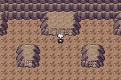 The player standing in front of the short braille wall at the back of the Sealed Chamber inner room